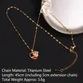Gold titanium steel heart necklace with red enamel and zircons on black background - Red Enamel Heart with Stones (A694)