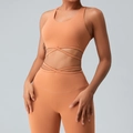 Two-piece coral orange yoga set featuring crop top and high-waisted leggings with cross ties - Camel