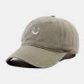 Close-up of white embroidered smiley face on a vintage washed cotton baseball cap - Adjustable / Light Khaki