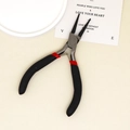 Detail of round nose jewelry pliers with ergonomic black and red handles on a beige surface - Round Nose Pliers / Black and Red Handle