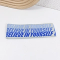 Light gray knitted yoga headband with Believe in Yourself text on a white background - Dark Blue