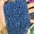 Deep blue faceted natural stone beads 2mm-3mm for jewelry making held in hand - Kyanite 3mm
