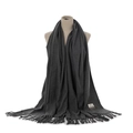 Detailed view of the dark grey cashmere-feel fringe scarf, showing soft texture and label. - Dark Heather Gray