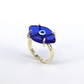 Detail of golden adjustable ring featuring a blue glass evil eye charm on white background - Adjustable Open / Dark Blue