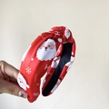Red Christmas knotted headband with Santa Claus prints and festive snowflake patterns - Printed Red
