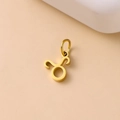 Delicate golden Taurus zodiac sign pendant in stainless steel on light background - Taurus / Gold
