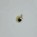 Detailed close-up of a golden moon pendant with green heart gemstone and white zircons - Gold Base - Green Zirconia