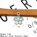 Macro shot of light blue enamel cherry blossom charm with pearl and size details - Blue (Pearl)