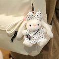 White plush bunny keychain in polka dot dress attached to a cream backpack - Black Polka Dot Dress Style