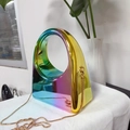 Detailed macro view of the iridescent rainbow acrylic clutch with gold ring handle - Rainbow Gradient