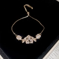 Macro detail of French style sparkling zircon flower bracelet with adjustable slider clasp - Rose Flower Slider Bracelet / Gold