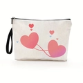 White canvas makeup bag featuring pink heart patterns and black wristlet strap - Style 1