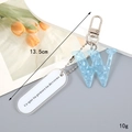 Detail of light blue acetate letter W keychain with silver clasp, 13.5cm long - Letter W
