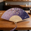 Japanese style folding fan featuring purple gradient sakura pattern with purple tassel - Purple Sakura Rain