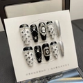 Handmade press-on nails with black bows, silver crosses, and vintage portrait cameo details - XS