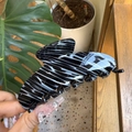 Macro shot of large black and white marbled acetate hair claw clip for thick hair - Large