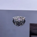 Detailed shot of star-shaped silver ring featuring a pink gemstone and micro-pave diamonds - Style 1 Star Open Ring
