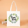 White canvas tote bag with green floral wreath and Team Bride print for bridesmaids - Leaf Logo