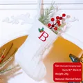 White knitted Christmas stocking with red letter B embroidery and green holly leaf decor - Letter B