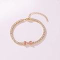 Detail view of a gold-tone tennis bracelet featuring pink heart-shaped cubic zirconia. - Heart to Heart Style (Pink Rhinestone) / Gold