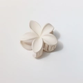 Macro detail of creamy white matte frangipani hair claw clip with rounded metal spring teeth - Matte White