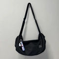 Black half-moon gym bag with adjustable strap and blue astronaut charm detail - Black + Astronaut