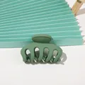 Close-up of matte dark green hair claw clip with a refined minimalist 5-tooth design - Matte Pumpkin - Army Green