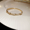 Detailed close-up of a 18k gold plated snake-style bangle with shimmering zircon stones - 18# Golden Bamboo