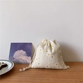 Detail of beige daisy floral drawstring pouch made of linen on a wooden table - 14cm*16cm / Off-White Daisy