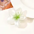 Detailed macro shot of a pearlescent white flower hair claw clip with green gradient finish - Pearlescent Green