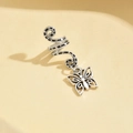 Macro view of silver alloy hair braid ring featuring a hollow butterfly charm pendant - Carved Butterfly Style (5#)