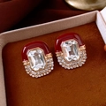 Macro view of vintage palace style earrings with red enamel and rectangular crystal - Silver Earring Post - Red