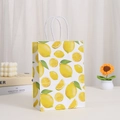 Detail view of lemon print paper bag with white twisted rope handles on a bright desktop - Fresh Lemon Hand-drawn (410-5) / 21cmx15cmx8cm