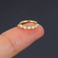 Golden cartilage earring with cubic zirconia studs held on fingertips for size scale - 2#-8mm / Gold