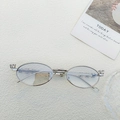 Silver oval metal glasses frames with rhinestones on a textured white surface - Silver Frame Light Gray Lens