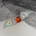 Halloween pumpkin hair clip with holographic bat wings on a spider web background - Silver Pumpkin