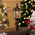 Detalle de farol navideño de bronce con Papá Noel y bola de agua luminosa con purpurina - Árbol de Navidad