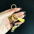 Detail of resin letter K keychain with real white flowers gold flakes and yellow tassel - Letter Y