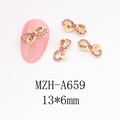 Detail showing pink rhinestone bow nail art charms on golden metal base 13x6mm size - Hollow Bowknot (A659)