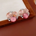 Close-up of pink gradient flower cluster earrings on a brown velvet jewelry box - Pink