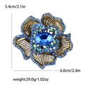 Spilla a fiore in oro antico con cristalli blu e grande gemma ovale centrale - Blu lago