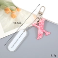 Pink marble texture resin letter X keychain with silver spring clasp and motto tag - Letter X
