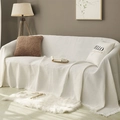 Beige waffle weave sofa cover with decorative fringe trim on a cozy modern couch - 90x90cm / White