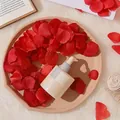 Cosmetic skincare serum bottle with dropper in a decorative setting of red rose petals - Red