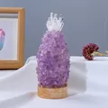 Pineapple shaped night light made of purple amethyst crystals on a round wooden base - Amethyst Pineapple Lamp