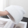 Detail of soft white faux fur knit beanie showing thick plush texture and ribbed cuff - Stretchy / White