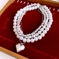 Detailed view of layered necklace with white pearls and a polished silver heart pendant - Multi-layer Layered Heart Necklace / Silver