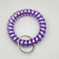 Detail view of purple spiral plastic coil keychain with a silver metal ring - Metallic Light Purple