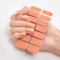 Close-up of DQ-08 peach-pink 3D nail stickers with golden ring accents on a hand - DQ-08 Coral Orange Spiral
