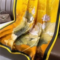 Elegant yellow silk scarf with lotus print displayed on a brown leather sofa - Bright Yellow Bronze Lotus (XL87-3) / 180x90cm